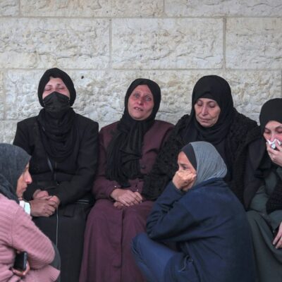 Mulheres choram após a morte de 36 pessoas da mesma família em Gaza, neste sábado