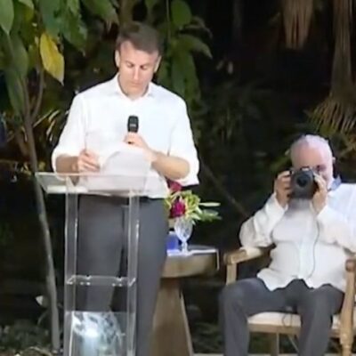 Na imagem, ao fundo Lula tira foto de Macron, que falava em palanque de ilha próxima a Belém