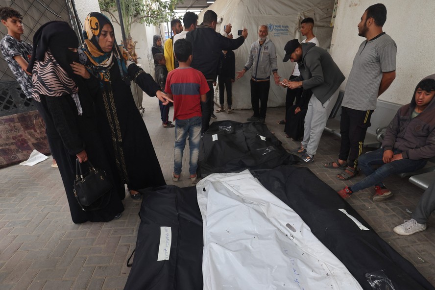 Palestinos se reúnem no hospital Al-Najjar para identificar os corpos de parentes após bombardeio israelense em Rafah.