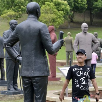 Turista passa por estátuas de Chiang Kai-shek em parque dedicado ao ditador na cidade de Taoyuan, no norte de Taiwan
