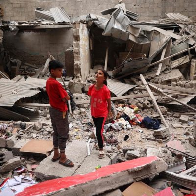 Crianças palestinas entre escombros de casa destruída por bombardeio israelense em Rafah, no sul da Faixa de Gaza