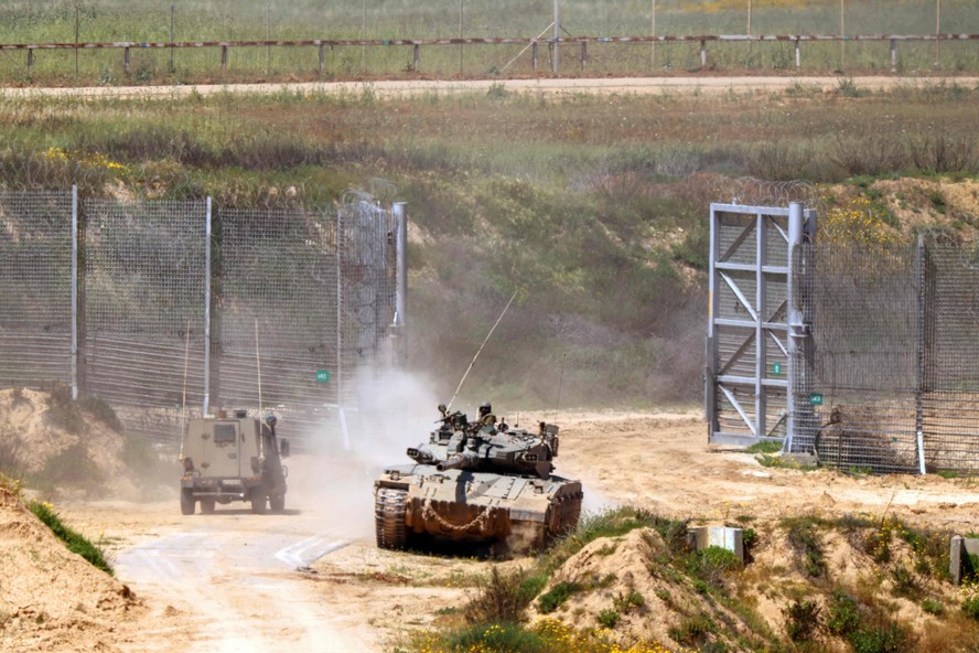 Veículos do exército israelense se movem em uma área ao longo da fronteira com a Faixa de Gaza e o sul de Israel