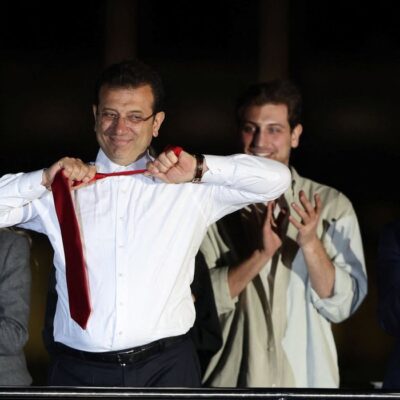 Istanbul Mayor Ekrem Imamoglu, mayoral candidate of the main opposition Republican People's Party (CHP), takes off his tie as he addresses his supporters following the early results in front of the Istanbul Metropolitan Municipality (IBB) in Istanbul, Turkey April 1, 2024. REUTERS/Umit Bektas