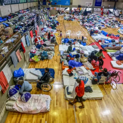 People who have been evacuated from flooded areas rest at a gym used as a shelter in Porto Alegre, Rio Grande do Sul state, Brazil May 10, 2024. REUTERS/Diego Vara