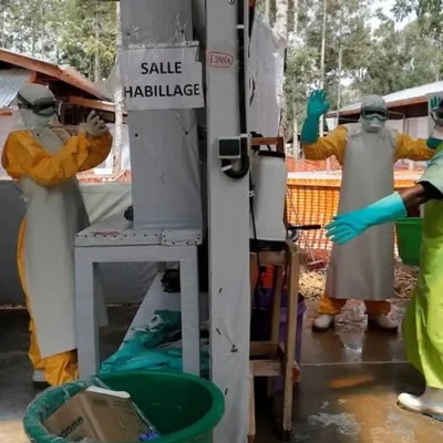 FILE PHOTO: An Ebola survivor who works as a nurse, gets dressed in a protective suit as he prepares to start his shift at an  Ebola treatment centre (ETC) in Katwa, near Butembo, in the Democratic Republic of Congo, October 2, 2019. REUTERS/Zohra Bensemra/File Photo