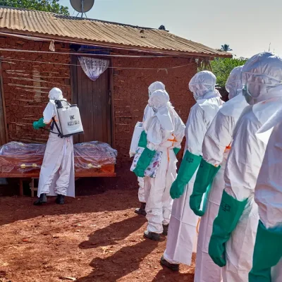 Red Cross workers wearing personal protective equipment (PPE) disinfect the house of an unidentified man who died of Ebola before retrieving his body, as aid agencies intensify efforts to contain a new Ebola outbreak involving the Bundibugyo strain, in Quartier Shuni 1, a residential sector in Mongbwalu, Djugu Territory of Ituri province, Democratic Republic of Congo, May 24, 2026. REUTERS/Gradel Muyisa Mumbere     TPX IMAGES OF THE DAY