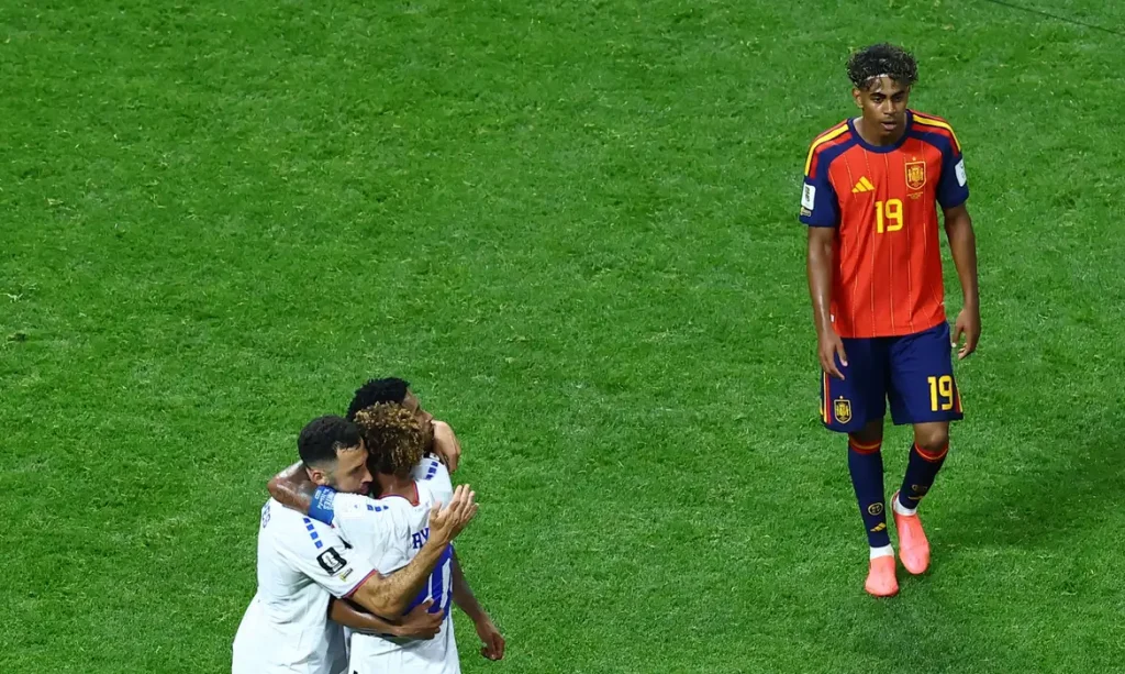 Soccer Football - FIFA World Cup 2026 - Group H - Spain v Cape Verde - Atlanta Stadium, Atlanta, Georgia, U.S. - June 15, 2026 Cape Verde's Pico Lopes, Ryan Mendes and Joao Paulo celebrate as Spain's Lamine Yamal looks dejected after the match REUTERS/Bernadett Szabo