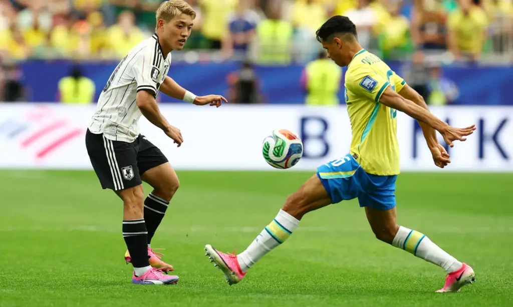 Soccer Football - FIFA World Cup 2026 - Round of 32 - Brazil v Japan - Houston Stadium, Houston, Texas, U.S. - June 29, 2026 Japan's Ritsu Doan in action with Brazil's Douglas Santos REUTERS/Phil Noble