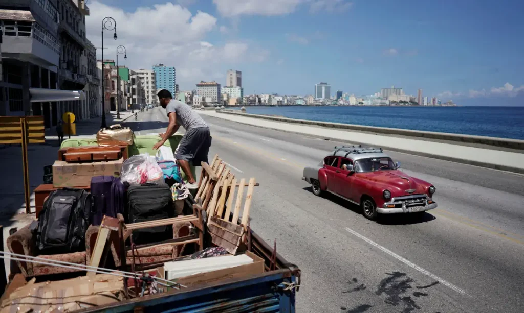 A man loads a truck with furniture to be relocated prior to the arrival of Storm Elsa, in Havana, Cuba, July 4, 2021. REUTERS/Alexandre Meneghini