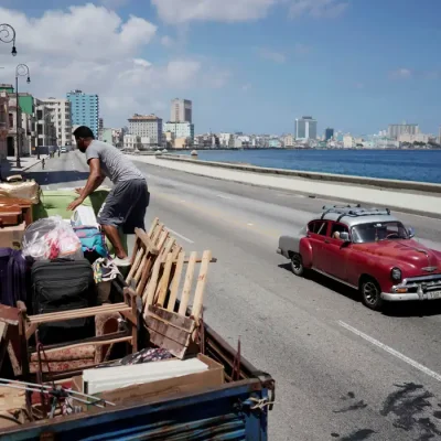 A man loads a truck with furniture to be relocated prior to the arrival of Storm Elsa, in Havana, Cuba, July 4, 2021. REUTERS/Alexandre Meneghini