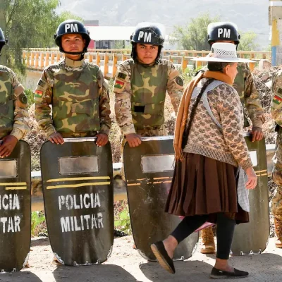 Military personnel stand in formation as they are deployed, while a woman walks past in front of them, after Bolivian President Rodrigo Paz declared a nationwide state of emergency following weeks of violence and blockades, in Cochabamba, Bolivia, June 20, 2026. REUTERS/Patricia PintoTPX IMAGES OF THE DAY