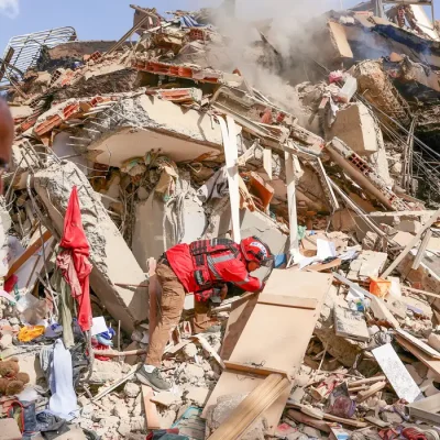 Juan Carlos Gomez, firefighter from Caracas, looks for his sister, Katiuska Hernandez, and nephew Brett Roude, amid the rubble of a building, after earthquakes hit the country, in La Guaira, Venezuela, June 25, 2026. REUTERS/Gaby Oraa