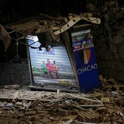 A person looks on near rubble at the site of a collapsed building, after an earthquake, in Caracas, Venezuela, June 24, 2026. REUTERS/Gaby Oraa