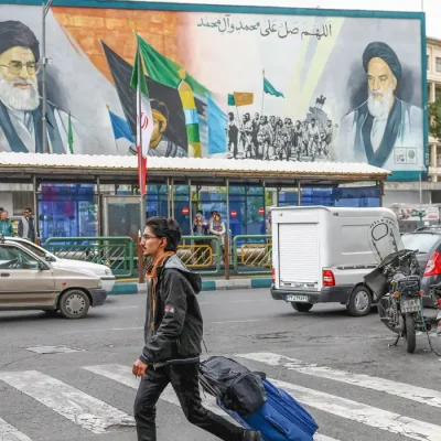 People walk next to a mural depicting the late leader of the Islamic Revolution Ayatollah Ruhollah Khomeini and the late Supreme Leader of Iran Ayatollah Ali Khamenei, in Tehran, Iran, April 12, 2026. Majid Asgaripour/WANA (West Asia News Agency) via REUTERS ATTENTION EDITORS - THIS PICTURE WAS PROVIDED BY A THIRD PARTY