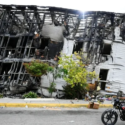 A motorist rides past a damaged building, after earthquakes hit the country, in La Guaira, Venezuela, June 28, 2026. REUTERS/Maxwell Briceno