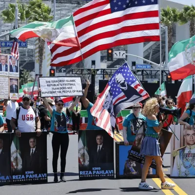 Soccer Football - FIFA World Cup 2026 - Group G - Iran v New Zealand - Los Angeles Stadium, Inglewood, California, U.S. - June 15, 2026 Banners of an Iranian political activist Reza Pahlavi and flags of the U.S. and Iran are displayed during a protest outside the stadium before the match REUTERS/Mike Blake