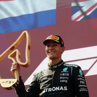 George Russell, da Mercedes, comemora com o troféu no pódio após vencer o Grande Prêmio da Áustria, 28 de junho de 2026. REUTERS/Leonhard Foeger