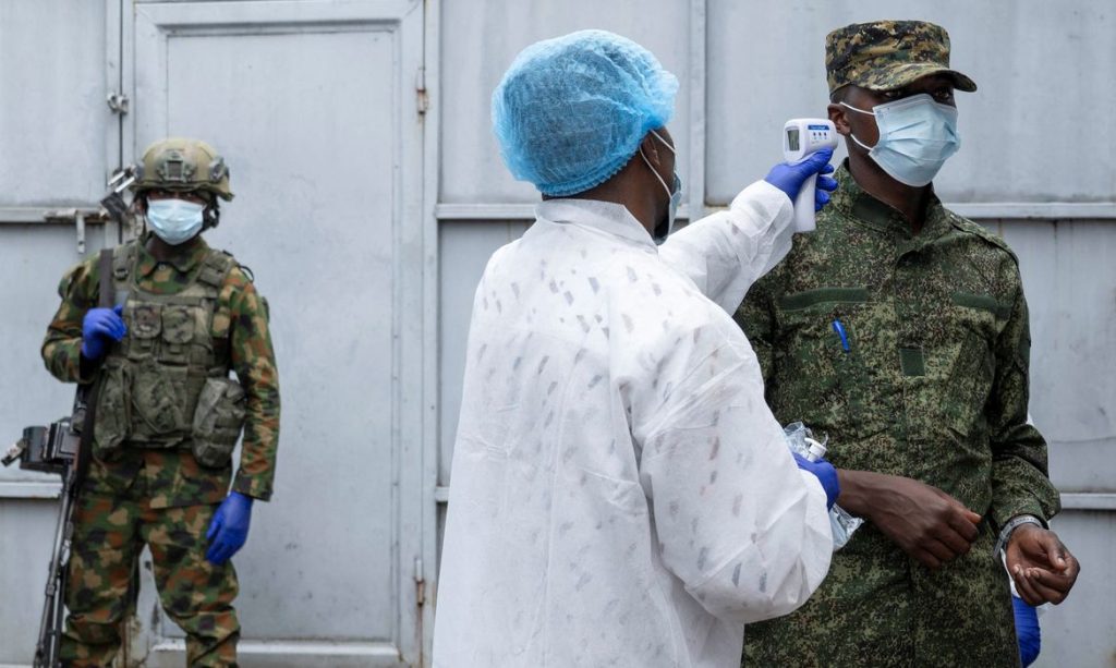 A health worker takes the temperature of an M23 rebel at the entrance to the Rodolphe Merieux Laboratory, National Biomedical Research Institute (INRB), where samples from suspected Ebola cases are examined, as part of the response to the epidemic in Goma, North Kivu province of the Democratic Republic of Congo, May 19, 2026. REUTERS/Arlette Bashizi