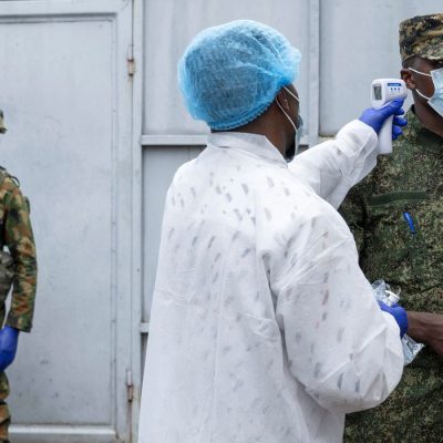 A health worker takes the temperature of an M23 rebel at the entrance to the Rodolphe Merieux Laboratory, National Biomedical Research Institute (INRB), where samples from suspected Ebola cases are examined, as part of the response to the epidemic in Goma, North Kivu province of the Democratic Republic of Congo, May 19, 2026. REUTERS/Arlette Bashizi