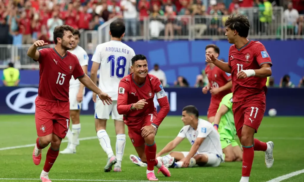 Soccer Football - FIFA World Cup 2026 - Group K - Portugal v Uzbekistan - Houston Stadium, Houston, Texas, U.S. - June 23, 2026 Portugal's Cristiano Ronaldo celebrates with Joao Felix and Joao Neves after Abduvohid Nematov scores an own goal and Portugal's fourth REUTERS/Phil Noble