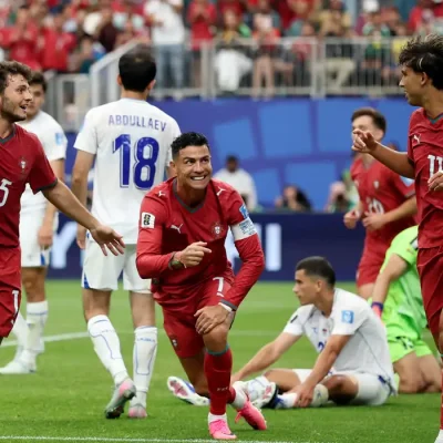 Soccer Football - FIFA World Cup 2026 - Group K - Portugal v Uzbekistan - Houston Stadium, Houston, Texas, U.S. - June 23, 2026 Portugal's Cristiano Ronaldo celebrates with Joao Felix and Joao Neves after Abduvohid Nematov scores an own goal and Portugal's fourth REUTERS/Phil Noble