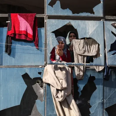 Palestinian women look on from behind broken windows, during the funeral of Palestinians who, according to medics, were killed by an Israeli strike on Saturday, at Al-Shifa Hospital in Gaza City, January 31, 2026. REUTERS/Dawoud Abu Alkas
