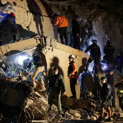 Emergency services work at the site of a collapsed building after earthquakes hit the country, in Caracas, Venezuela, June 24, 2026. REUTERS/Gaby Oraa