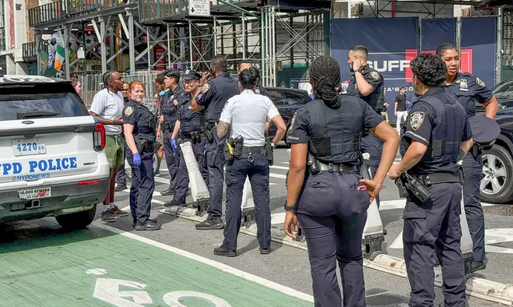 New York Police Department officers gather after alleged gunfire was heard in Times Square, in New York City, U.S., June 18, 2026.  Picture taken with a phone. REUTERS/Andrew Hofstetter