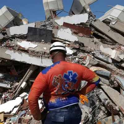 A member of Civil Protection looks at rubble of a collapsed building in the aftermath of the June 24 earthquakes in La Guaira, Venezuela, July 1, 2026. REUTERS/Ricardo Arduengo