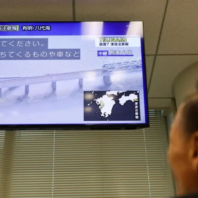 Tela de televisão exibindo imagens de uma ponte desabada após um terremoto com magnitude preliminar de 7,1 ter atingido a província de Kumamoto, no sul do Japão, em Tóquio, Japão, em 28 de julho de 2026
REUTERS/Issei Kato