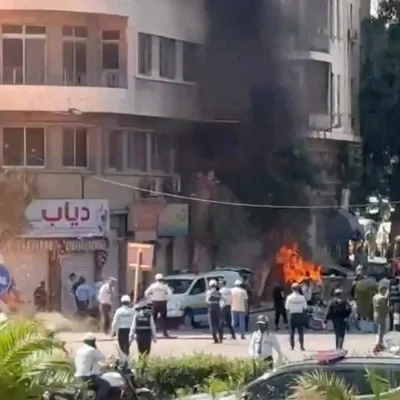 Emergency personnel work as smoke and fire rise at the site where explosive devices blew up near a hotel where French President Emmanuel Macron was meant to be staying, in Damascus, Syria, in this screengrab obtained from a video, July 7, 2026. REUTERS/Yamam Al Shaar TPX IMAGES OF THE DAY