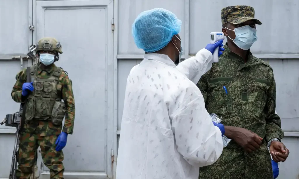 A health worker takes the temperature of an M23 rebel at the entrance to the Rodolphe Merieux Laboratory, National Biomedical Research Institute (INRB), where samples from suspected Ebola cases are examined, as part of the response to the epidemic in Goma, North Kivu province of the Democratic Republic of Congo, May 19, 2026. REUTERS/Arlette Bashizi