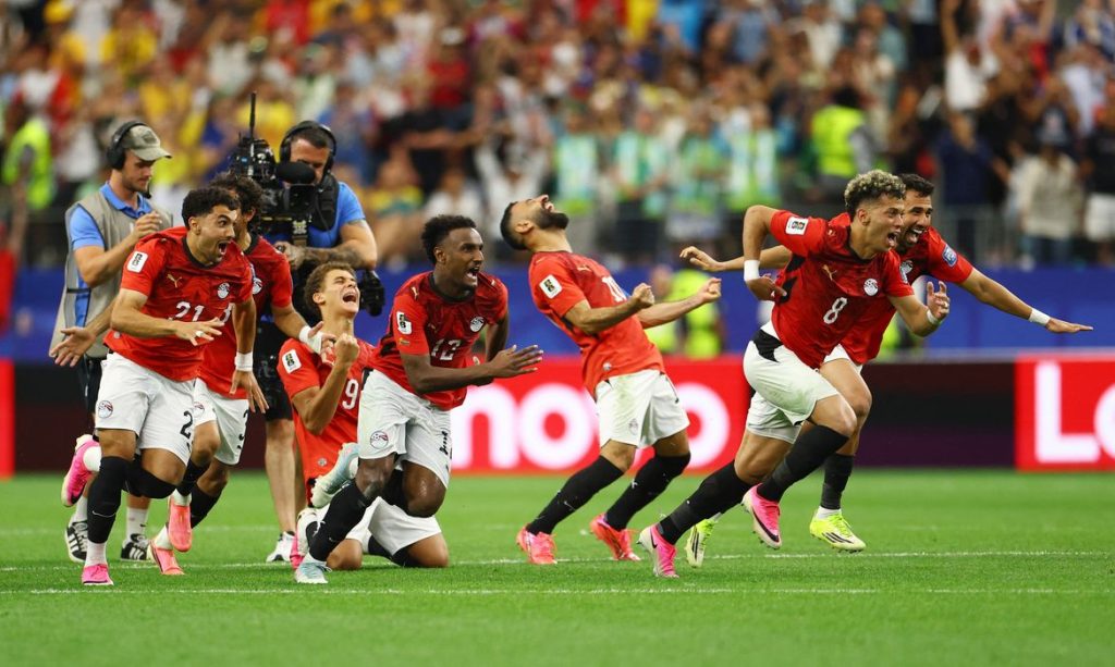 Soccer Football - FIFA World Cup 2026 - Round of 32 - Australia v Egypt - Dallas Stadium, Arlington, Texas, U.S. - July 3, 2026 Egypt players celebrate after Hossam Abdelmaguid scores the penalty past Australia's Mathew Ryan to win the shoot-out as Egypt qualify for the Round of 16 stage of the World Cup REUTERS/Hannah Mckay