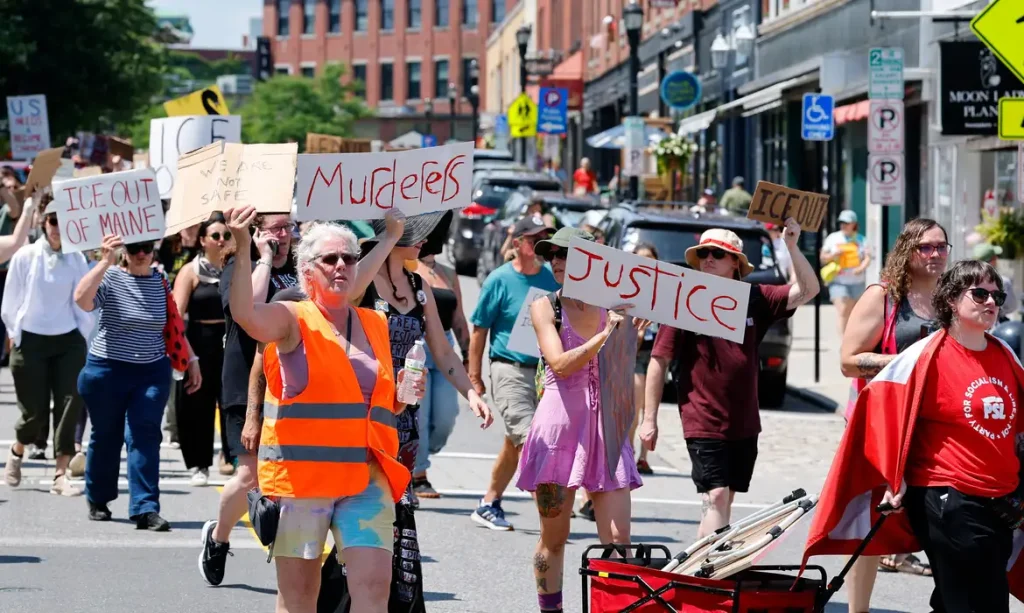 People take part in a protest after a shooting involving U.S. Immigration and Customs Enforcement (ICE) in Biddeford, Maine, U.S. July 13, 2026.  REUTERS/CJ Gunther
