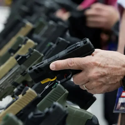 FILE PHOTO: A person tries out a handgun during the National Rifle Association (NRA) annual convention in Indianapolis, Indiana, U.S., April 15, 2023. REUTERS/Evelyn Hockstein/File Photo