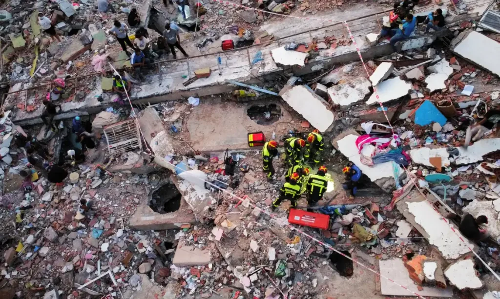 A drone view of members of a Slovakian rescue team taking part in rescue efforts at the site of a collapsed building in the Mision Vivienda government residential complex, in the aftermath of the June 24 earthquakes, in Los Cocos, in La Guaira state, Venezuela, July 1, 2026. REUTERS/Leonardo Fernandez Viloria