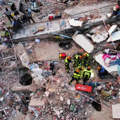A drone view of members of a Slovakian rescue team taking part in rescue efforts at the site of a collapsed building in the Mision Vivienda government residential complex, in the aftermath of the June 24 earthquakes, in Los Cocos, in La Guaira state, Venezuela, July 1, 2026. REUTERS/Leonardo Fernandez Viloria