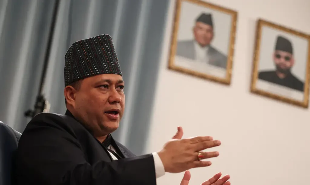 Nepal's Foreign Minister Shisir Khanal speaks in front of portraits of Nepal's President Ramchandra Paudel and Prime Minister Balendra Shah, during an interview with Reuters at the Embassy of Nepal in Beijing, China, June 16, 2026. REUTERS/Tingshu Wang