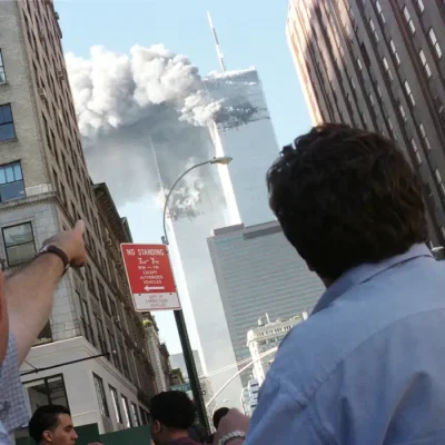 Pedestrians react to the World Trade Center collapse September 11, 2001. Two commercial airplanes cr..