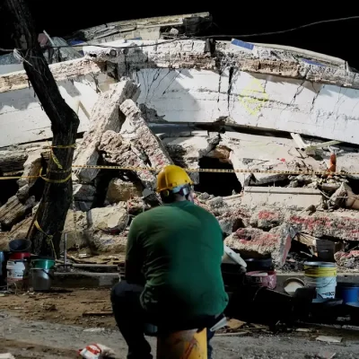 FILE PHOTO: A man sits near debris at the Torres de Limonar building in the aftermath of an earthquake, in Cali, Colombia, August 11, 2026. REUTERS/Sergio Acero TPX IMAGES OF THE DAY/File Photo