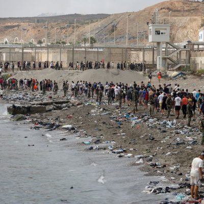 People walk towards the border with Morocco leaving Spain, amid mass crossings of migrants on foot and by sea from Morocco into Spanish territory, in Ceuta, Spain, July 31, 2026. REUTERS/Jon Nazca TPX IMAGES OF THE DAY