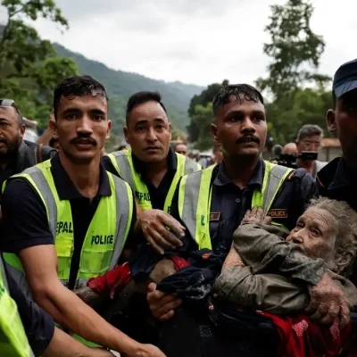 Police officers carry a survivor to a safer place following a flash flood at Trishuli in Nuwakot district, Nepal, August 26, 2026. REUTERS/Navesh Chitrakar REFILE - QUALITY REPEAT    TPX IMAGES OF THE DAY