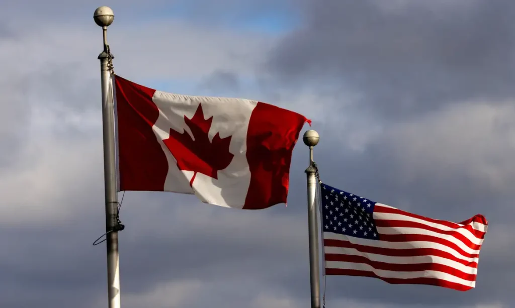 Flags wave in the wind near the Detroit River which seperates Windsor, Ontario, Canada, and Detroit, Michigan, U.S., in Windsor, Ontario, Canada February 4, 2025. REUTERS/Carlos Osorio