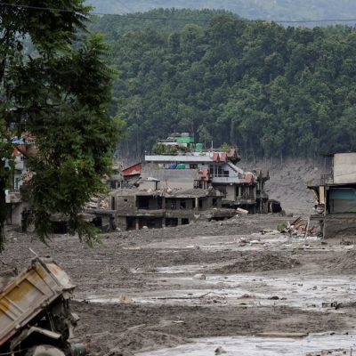 Mud covers houses and a road following a flash flood at Trishuli in Nuwakot district, Nepal, August 26, 2026. REUTERS/Navesh Chitrakar