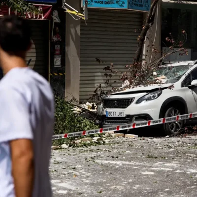 A fallen tree branch lies atop a damaged vehicle on a street in the aftermath of an earthquake that struck southern Spain, in Granada, Spain, August 18, 2026. REUTERS/Fermin Rodriguez