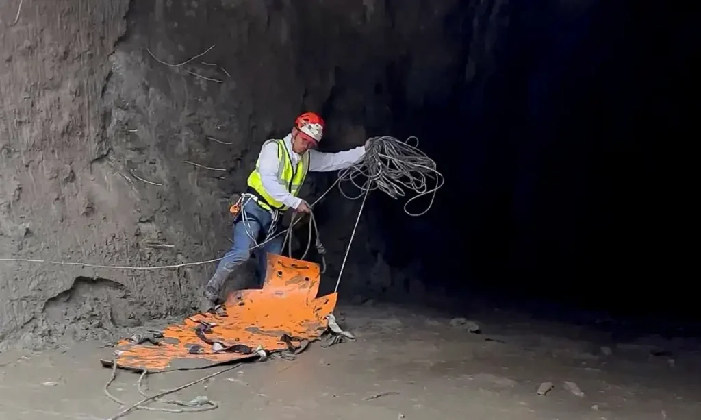 A rescuer works at the entrance of a tunnel at Chilime Hydropower Plant as rescue operations continue for people trapped inside following deadly flash floods and a mudslide, in Rasuwa, Nepal, August 29, 2026, in this screengrab obtained from a social media video. Ashish Gurung/via REUTERS  THIS IMAGE HAS BEEN SUPPLIED BY A THIRD PARTY. MANDATORY CREDIT. NO RESALES. NO ARCHIVES. THIS PICTURE WAS CROPPED BY REUTERS TO ENHANCE QUALITY. AN UNCROPPED VERSION HAS BEEN PROVIDED  VERIFICATION: - Reuters was able to match the building layout and mountain terrain with topography imagery of the area.  - Nepal National Mountain Guide Association have said they are conducting rescue operations at the tunnel.