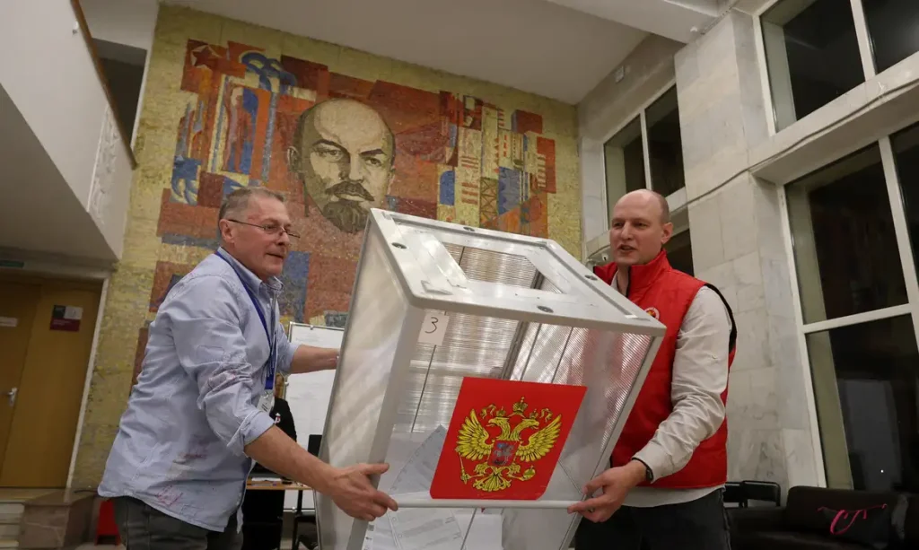 Members of a local electoral commission empty a ballot box before counting votes after the closure of a polling station, located in a cultural centre decorated with a mosaic depicting Soviet state founder Vladimir Lenin, on the final day of Russia's three-day parliamentary election in the town of Podolsk near Moscow, Russia, September 20, 2026. REUTERS/Ramil Sitdikov