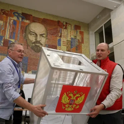 Members of a local electoral commission empty a ballot box before counting votes after the closure of a polling station, located in a cultural centre decorated with a mosaic depicting Soviet state founder Vladimir Lenin, on the final day of Russia's three-day parliamentary election in the town of Podolsk near Moscow, Russia, September 20, 2026. REUTERS/Ramil Sitdikov