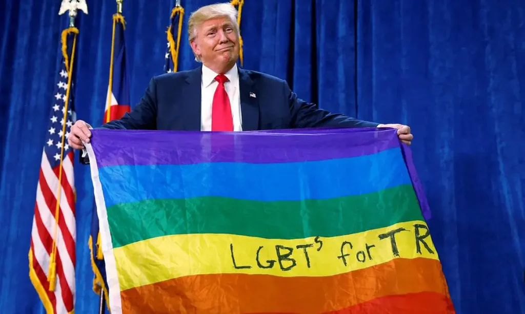 Donald Trump holds up a rainbow flag with