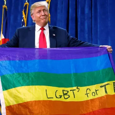 Donald Trump holds up a rainbow flag with